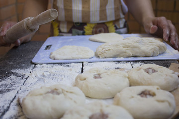 the girl prepares a pie with meat and onions