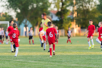 Fototapeta premium Kids soccer football - children players exercising before match on soccer field