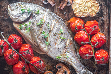 Grilled fish with thyme and cherry tomatoes