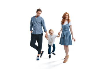 Naklejka premium Happy family with one child holding hands and walking isolated on white