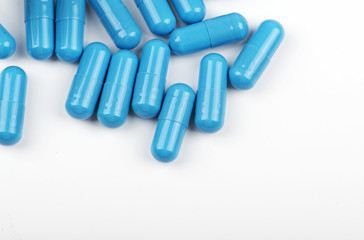 Blue pills on white background