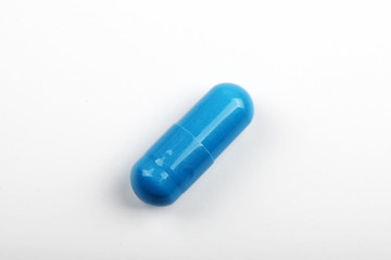 Blue pill on white background