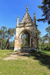 Fototapeta na wymiar Small temple of the Saint Hubert by the trees