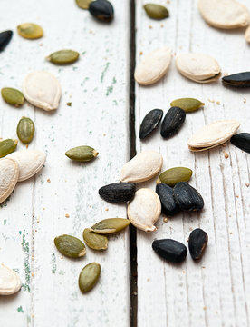 Different seeds on a wooden background