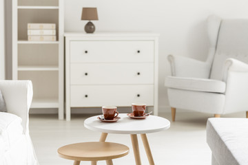 Tea cups in white room