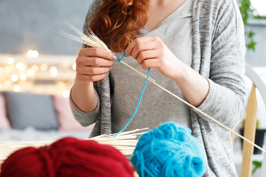 Woman making yarn decorations