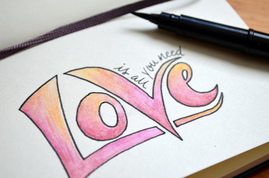 ALL YOU NEED IS LOVE hand lettering in notebook