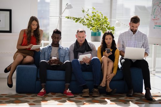 Business Colleagues Using Electronic Devices