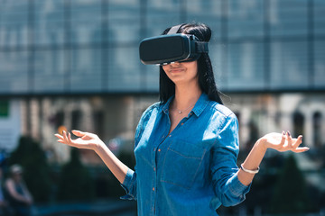 Young gamer girl using the new VR system, happy to reenact her favorite place from her beloved...