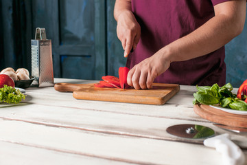 Closeup hand of chef baker making pizza at kitchen