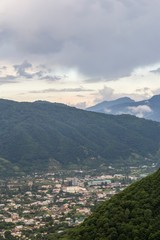 Fototapeta na wymiar красивый вид на город между горами, зеленые склоны, вид сверху, горный пейзаж, Северный Кавказ