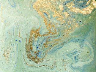 Marbled blue, green and golden abstract background. Liquid marble pattern.