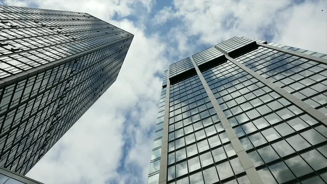 Time lapse of clouds over corporate buildings