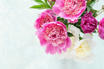 Peonies. Beautiful bouquet of pink white and purple peonies in vase on bright background. Closeup shot selective focus. Wedding bouquet, mothers day gift, women's day gift © Vladislav Noseek