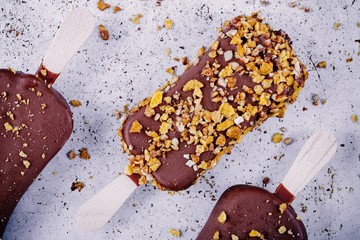 chocolate ice cream popsicle on rustic background