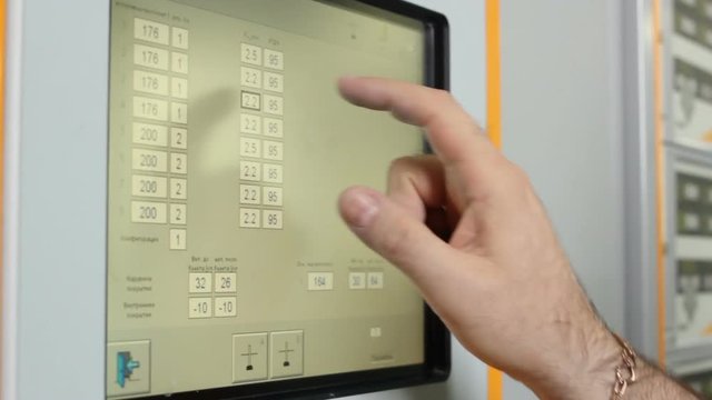 Closeup Man Hand Presses Buttons on Touch Pad Display