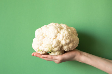Woman holding a beautiful fresh raw cauliflower