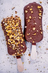 chocolate ice cream popsicle on rustic background