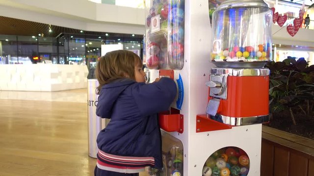 Fethiye, Turkey - 22th of December, 2016:  Erasta shopping center - 4K Kid gets a coin and plays in lotto slot machine