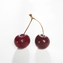 the Uzbek ripe cherry on a white wooden table. Copy space