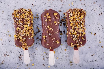 chocolate ice cream popsicle on rustic background