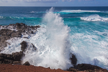 Fototapeta na wymiar Majestic ocean waves crash against the black rocks of volcanic coastline of Atlantic ocean on Lanzarote island, Canary Islands, Spain