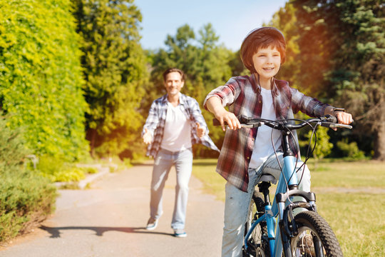 Genuine Focused Kid Riding A Bike For The First Time