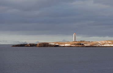 Kálfshamarsvik lighthouse among basalt columns in Iceland
