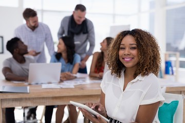 Young female executive using digital tablet in the office
