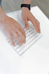 Fototapeta na wymiar Close up of male hands typing on keyboard