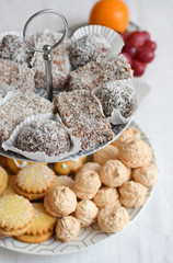 Several types of coconut pastry with macaroons, sponge cakes, filled cookies and honey cakes on a...
