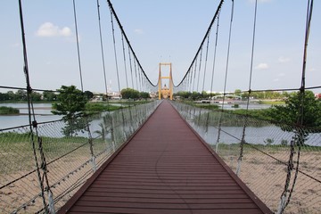 Obraz premium Yellow Suspension Bridge Architecture With doors blocking the passage that can pass through. Which is considered to be very popular.