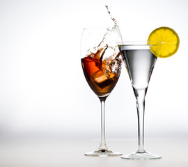 red wine action splash shot glass with Gin & Toic Ice and Lemon on white 