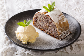 Sliced poppy strudel with vanilla ice cream close-up. horizontal