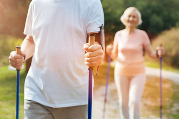 Close up of mans hand holding walking poles