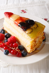 Slice of fruit berry cake close-up on a plate. Vertical