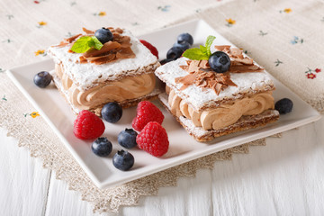 sliced chocolate cake with raspberries and blueberries close-up. horizontal