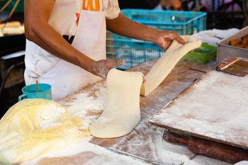 Man cooks youtiao at the street market