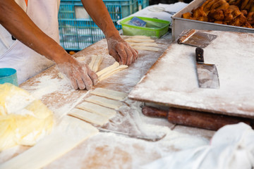 Man cooks youtiao at the street market