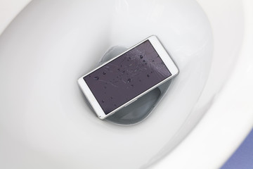 Broken mobile phone dropped into toilet bowl