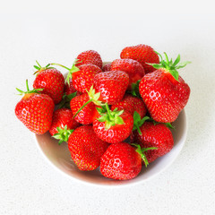 strawberries on dish / bright juicy berry close-up