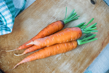 Fresh raw carrots on a wooden Kitchen cutting board. Vegetables from the garden
