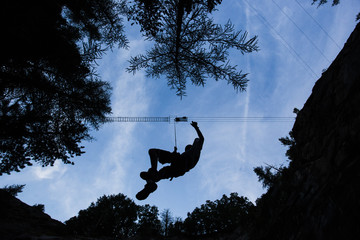 Silhouette of an abseiling climber