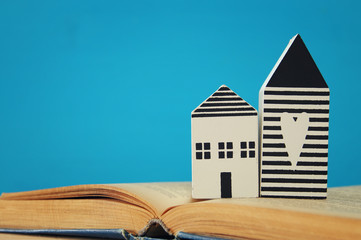 Obraz premium small house model over open book. selective focus