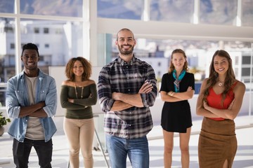 Group of colleagues standing with arms crossed