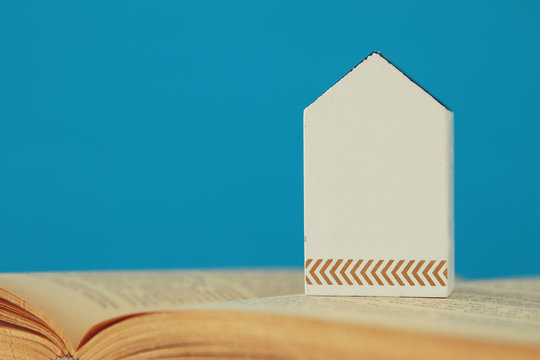 small house model over open book. selective focus