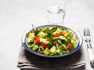 Healthy avocado spinach tomato salad. Gourmet dieting