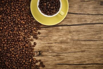 Cup of coffee beans with wooden table
