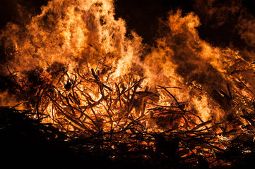 Burning pile of wood, big orange flames