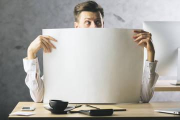 Surprised businessman with empty paper